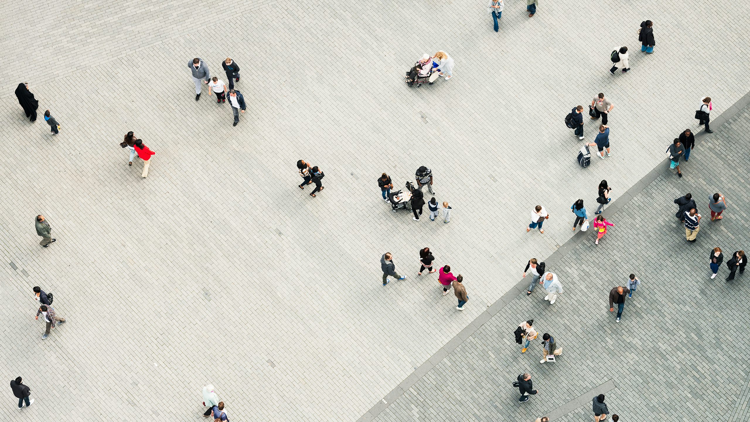 A corporate citizenship poster with a blurred background and a focus on a person's hand holding a globe.