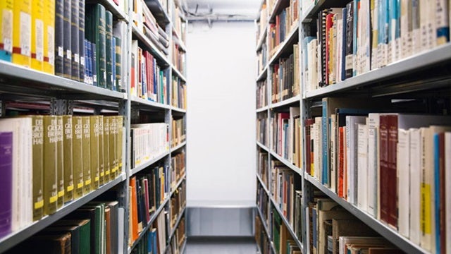 View down a row of books in a library.