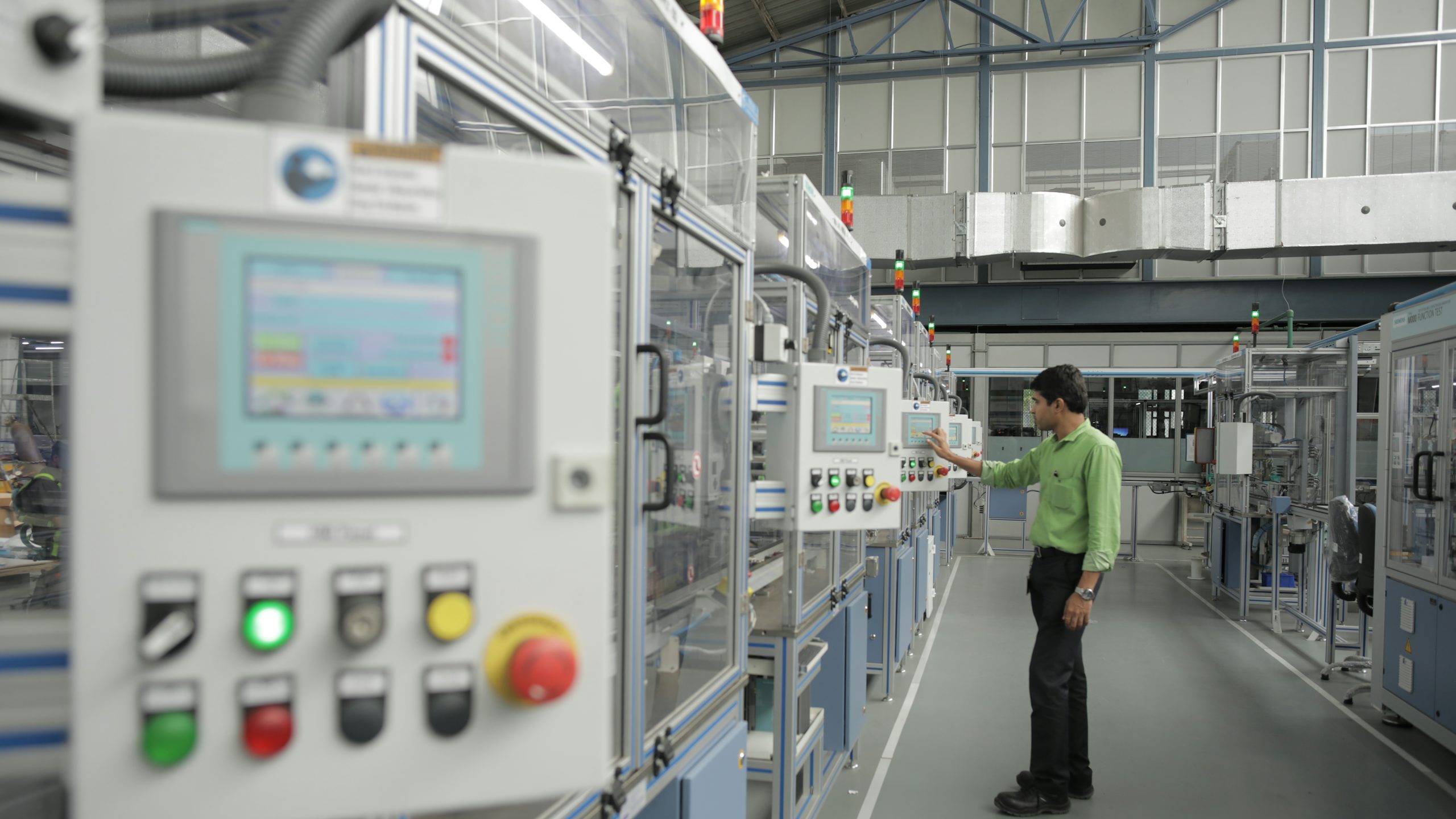 A factory with a large building and machinery equipment inside, possibly a switchgear factory.