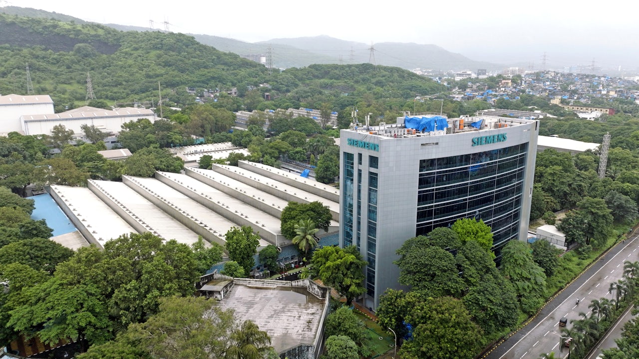 A Siemens building with a modern architectural design and a blue sky in the background.