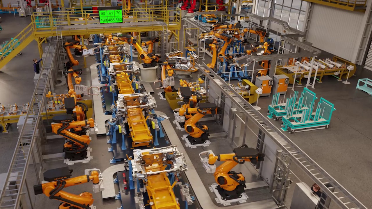 A manufacturing plant with robots on the factory floor making products.