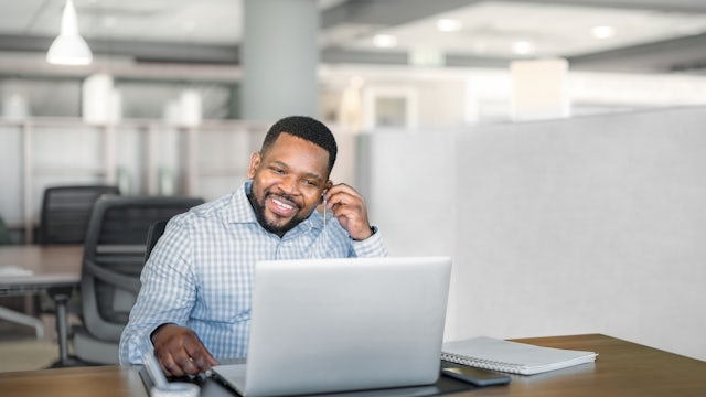 Man sitting in front of a laptop taking a video call.