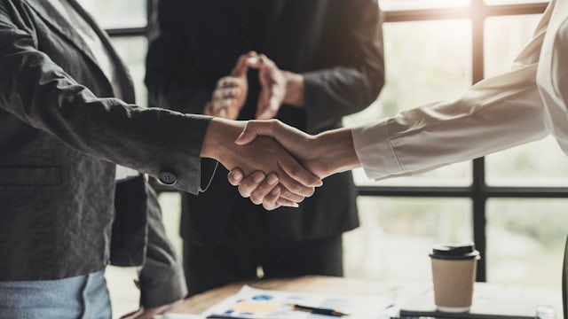 Two people shaking hands.