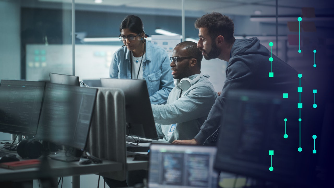 Three people looking at a computer together