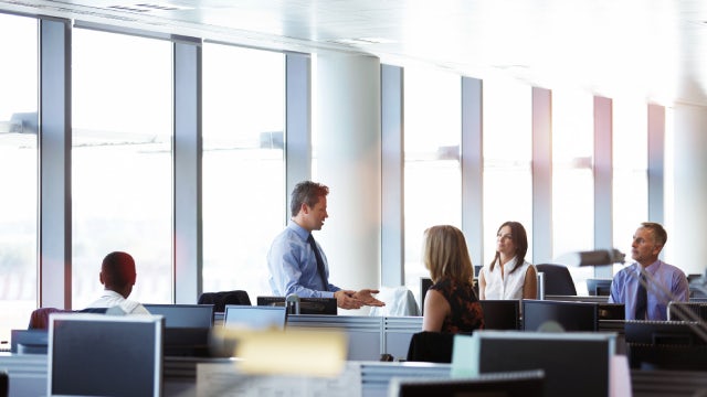 Many people speaking together in an office environment