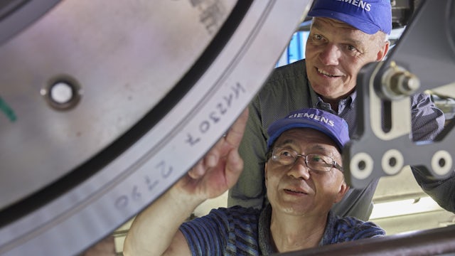 A man and a woman are standing close to each other, possibly posing for a photograph.