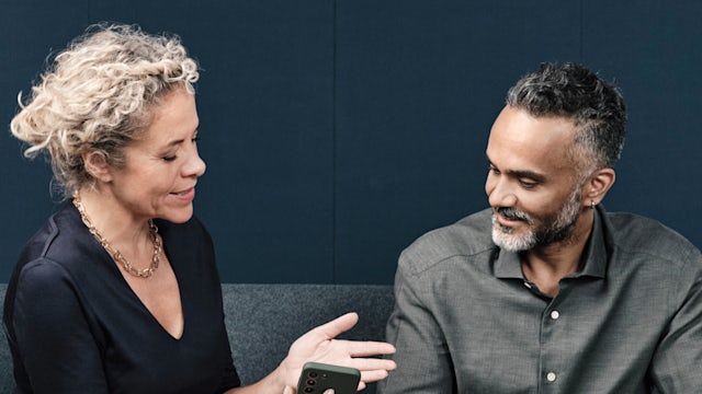 Woman and man engage in conversation. 