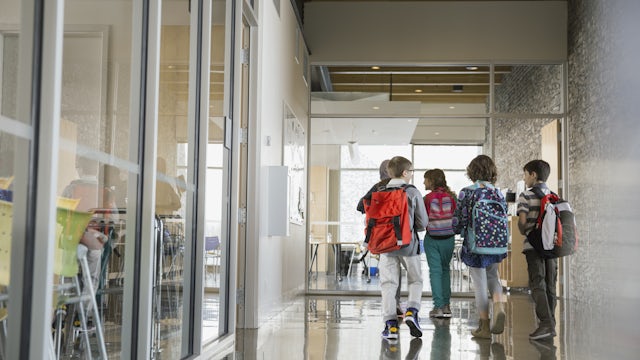 School children with backpacks, walking to class.
