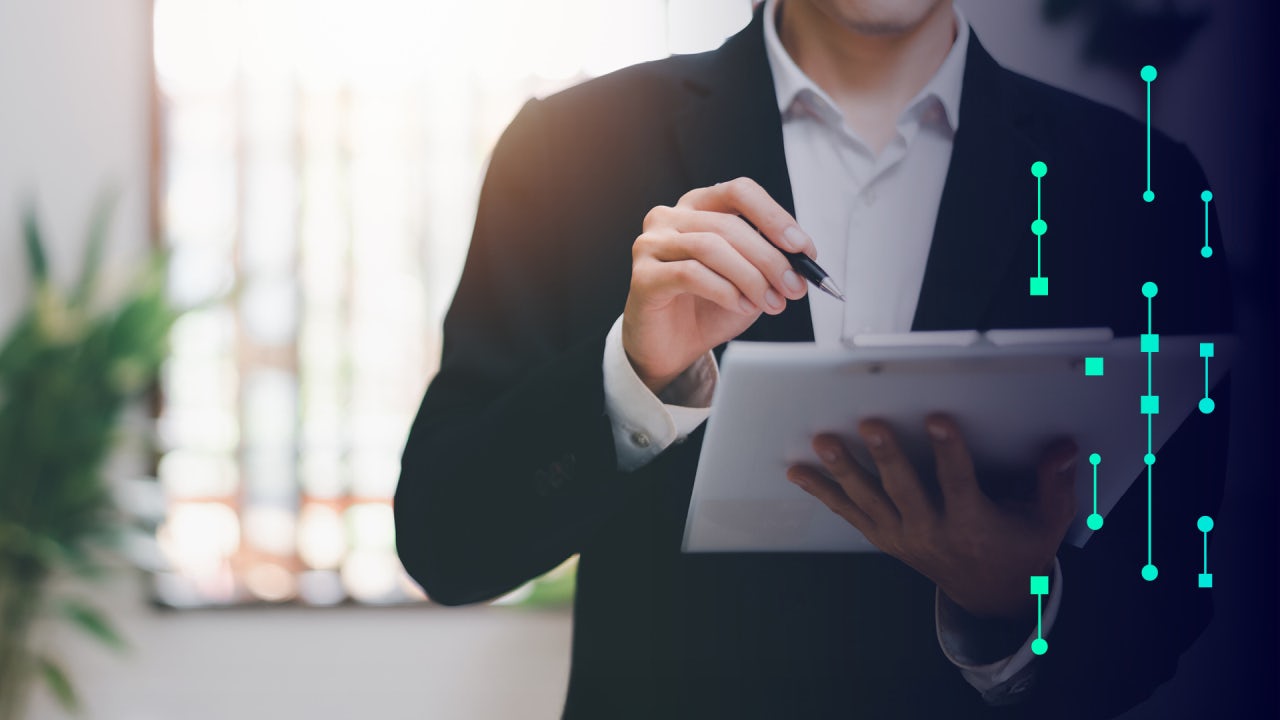 Man in a suit working on clipboard