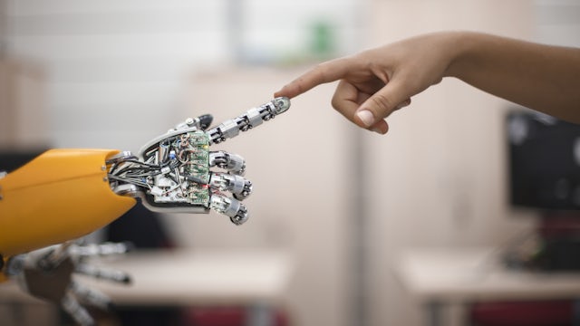 Image a human finger touching a robot finger.