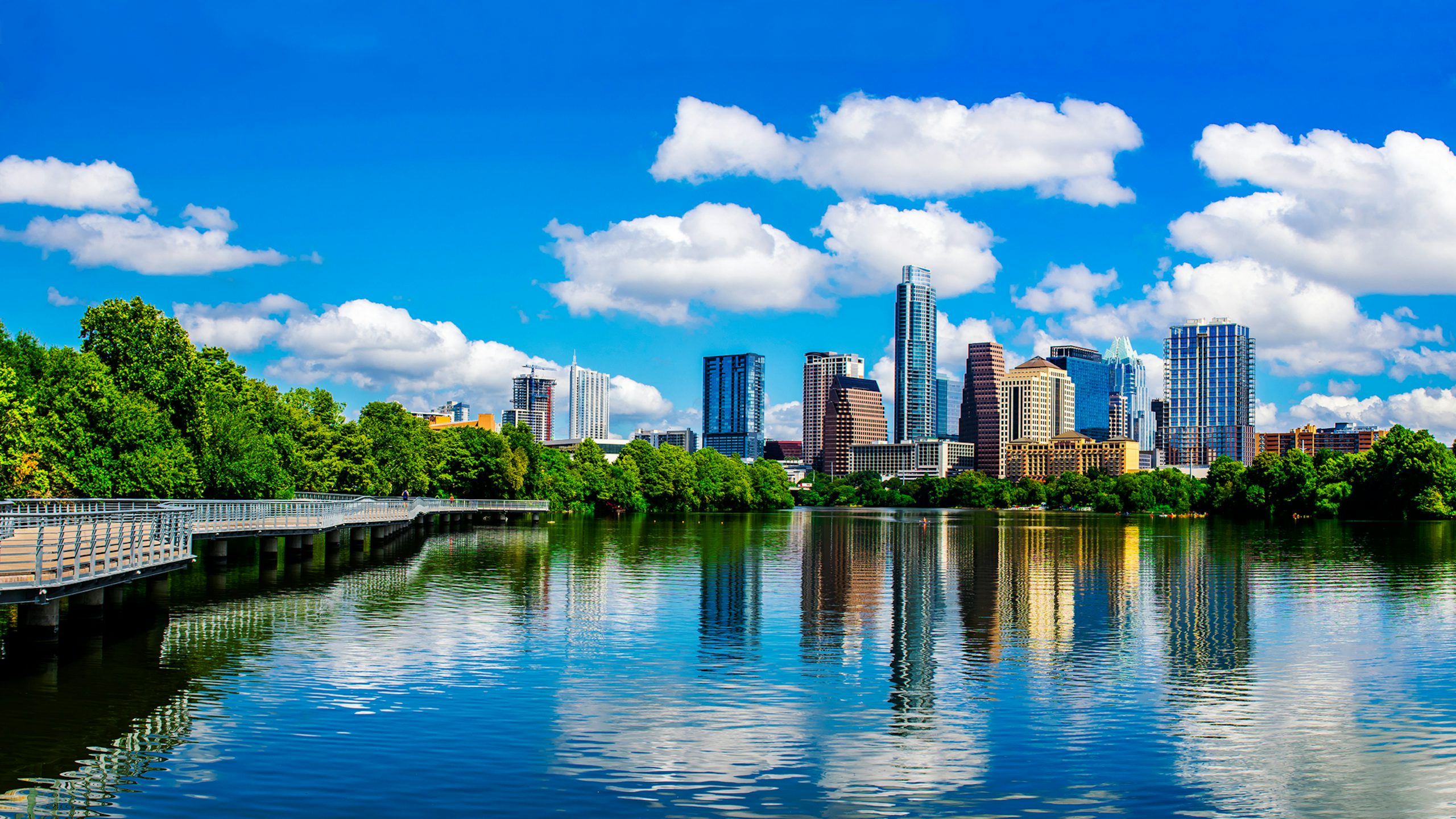A panoramic view of a city skyline at night with buildings and lights.