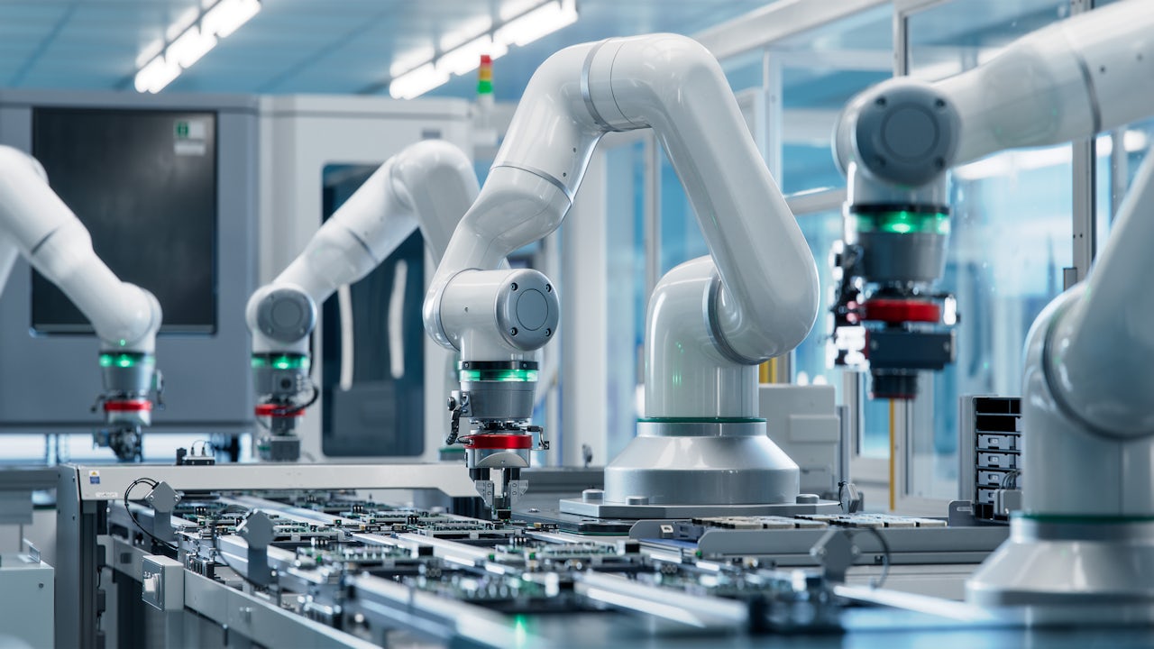 An industrial automation robot arm is shown in a factory setting, performing a task with precision and efficiency.
