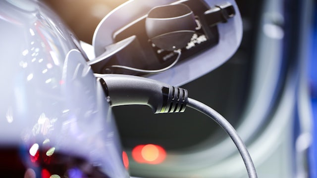 An electric vehicle plugged into a charger.