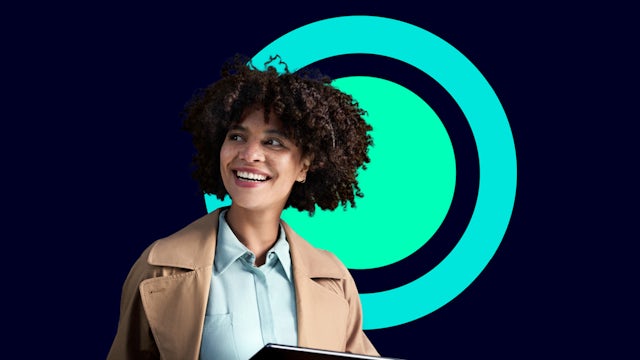 A woman holding a tablet and smiling.