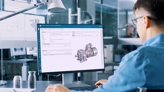An engineer works with CAD software to design a new machine component product.