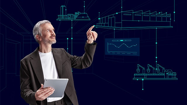 Person holding a tablet and interacting with virtual industrial diagrams and data visualizations projected in front of a dark blue background.