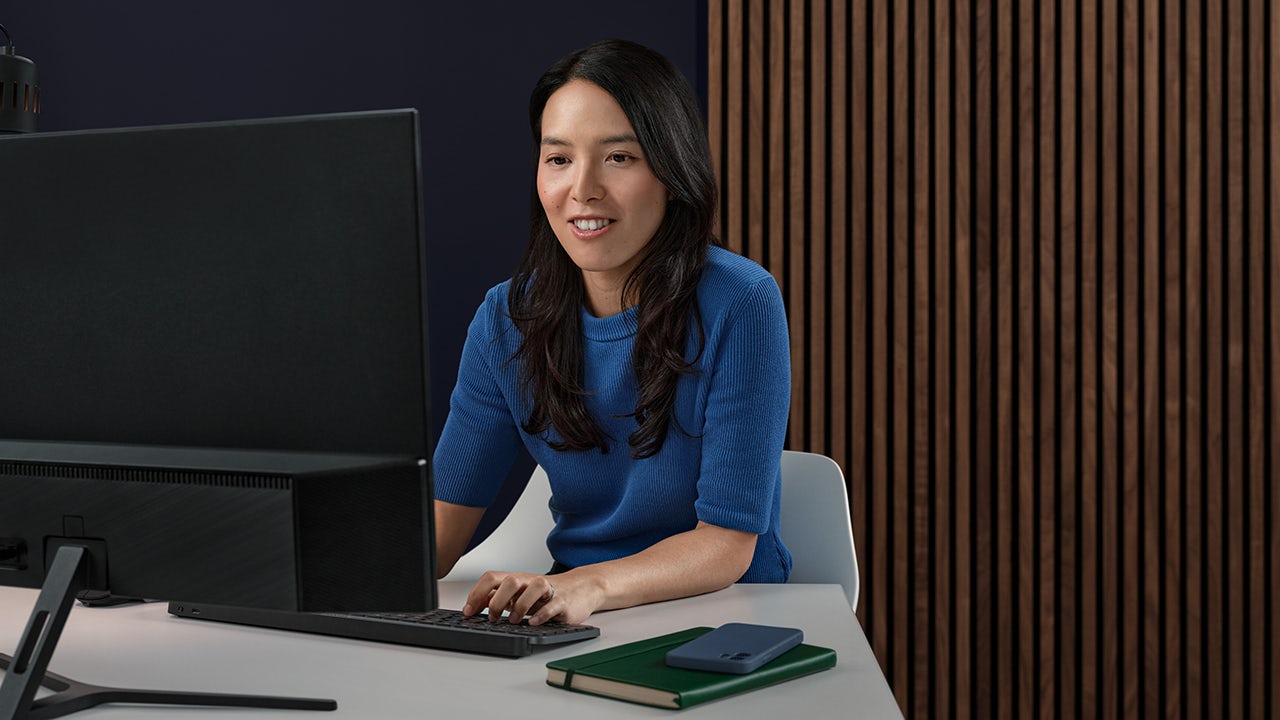 A person is using a computer to apply for a job, with the screen displaying a form and the person's hand on the keyboard.