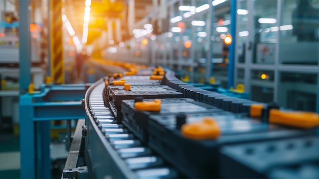 A line of batteries on an assembly line with a blurred background