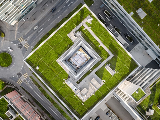 A modern building with a glass facade and a sign that reads "Building Services" and "Building Automation Services".