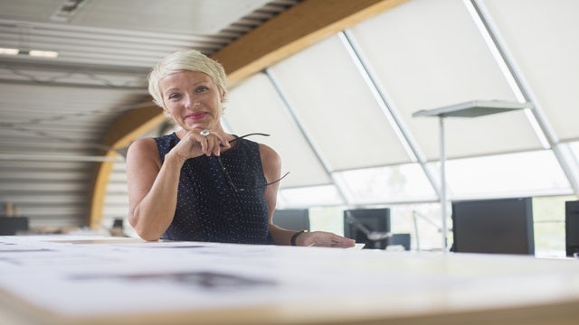 Business woman smiling in an office.