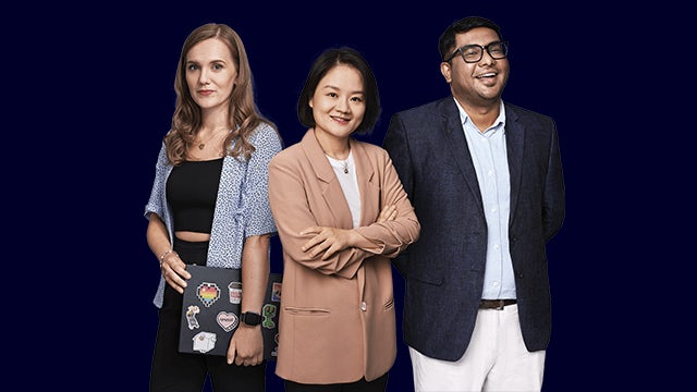 Two people in hard hats and safety vests examining equipment in an industrial setting.