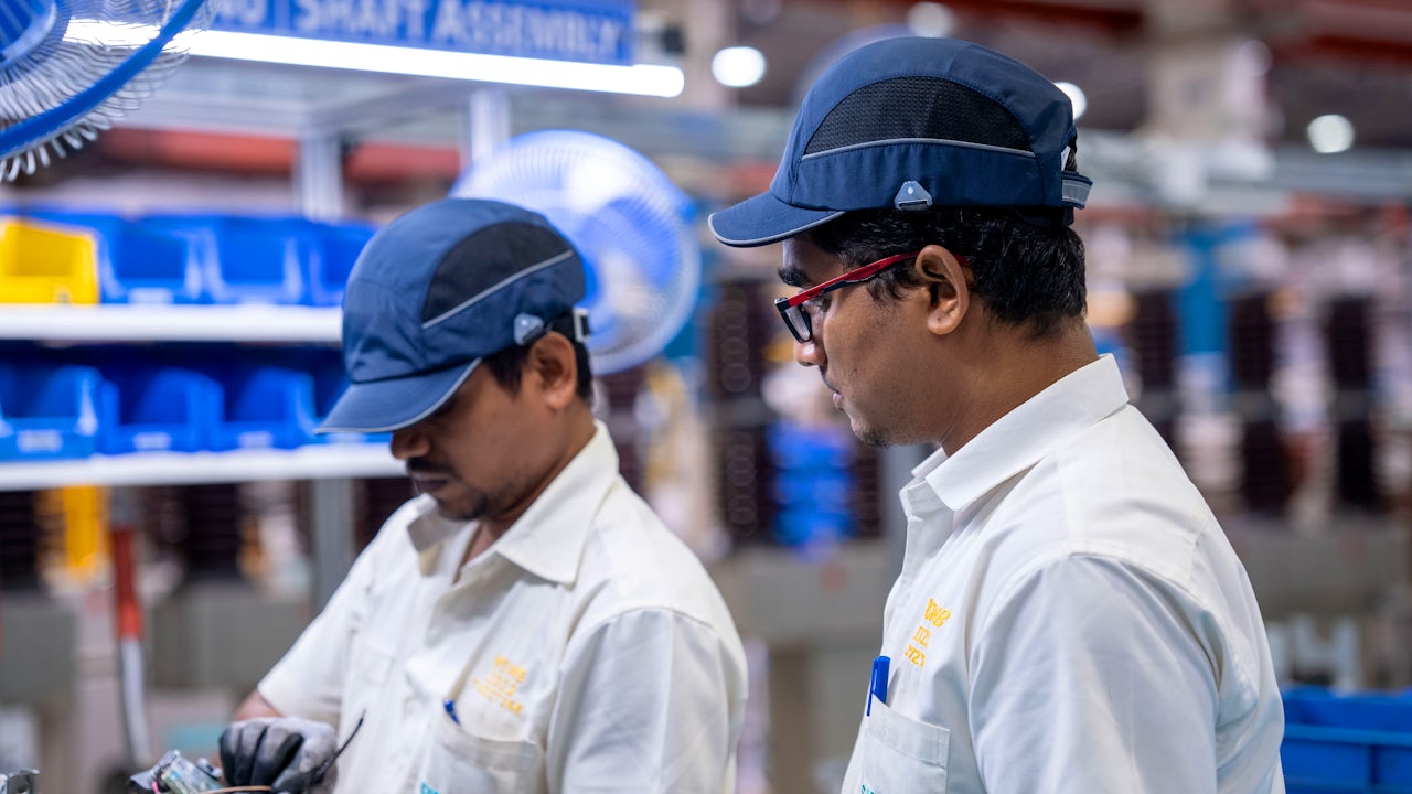 Group of professionals in business attire posing in front of a Siemens corporate building entrance