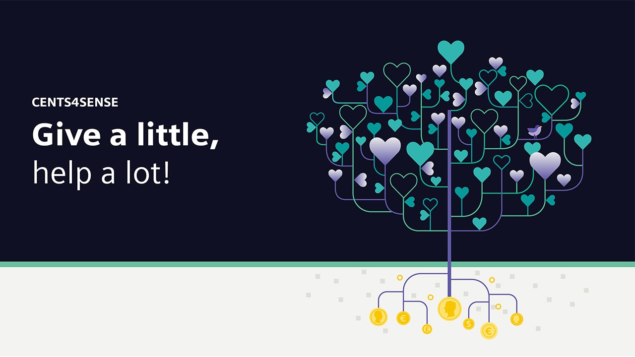 A person holding a donation box with a smiling face and a blurred background.