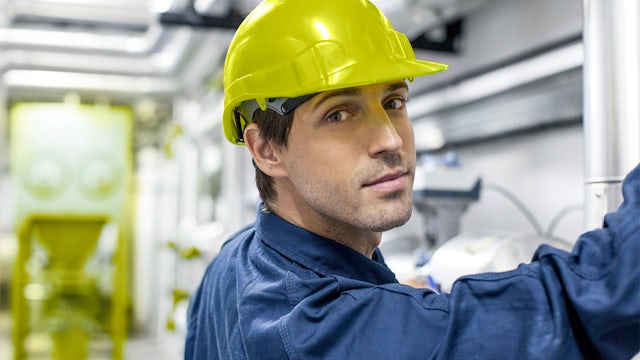 A chemical industry plant with a large tank and machinery for fertilizer production.