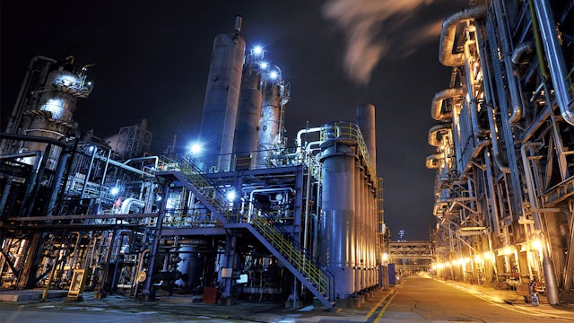 A chemical industry process consulting solution with a person in a lab coat and safety goggles.