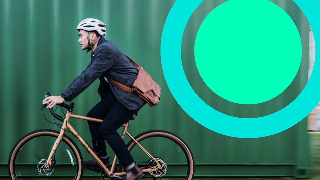 Young man riding a bicycle to work.