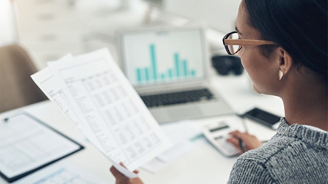 Closeup shot of an unrecognisable businesswoman calculating finances in an office.