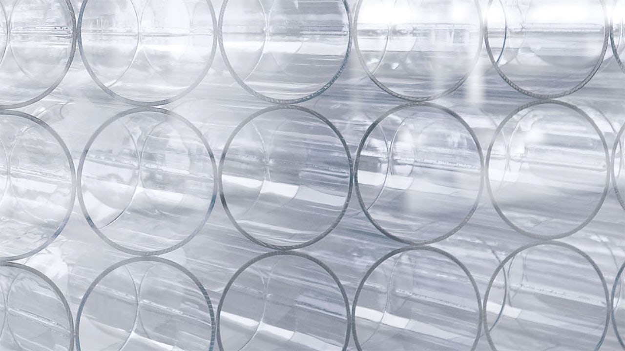 A visual representation of a glass with a reflection of a person and a document, symbolizing integrity and compliance.