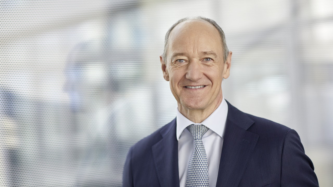 Professional businessman presenting data on large screen during corporate presentation