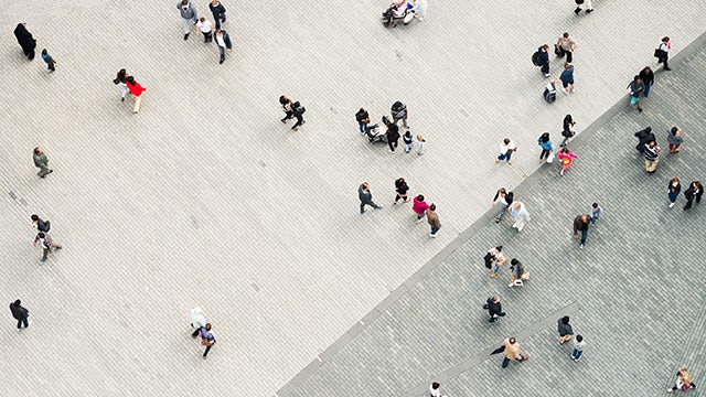 A corporate citizenship feature image showing a diverse group of people working together in a modern office setting.