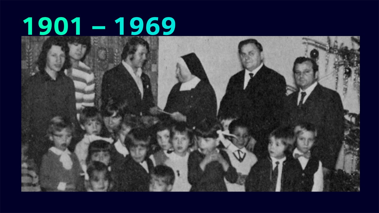 A corporate citizenship event with a diverse group of people standing together in front of a building.