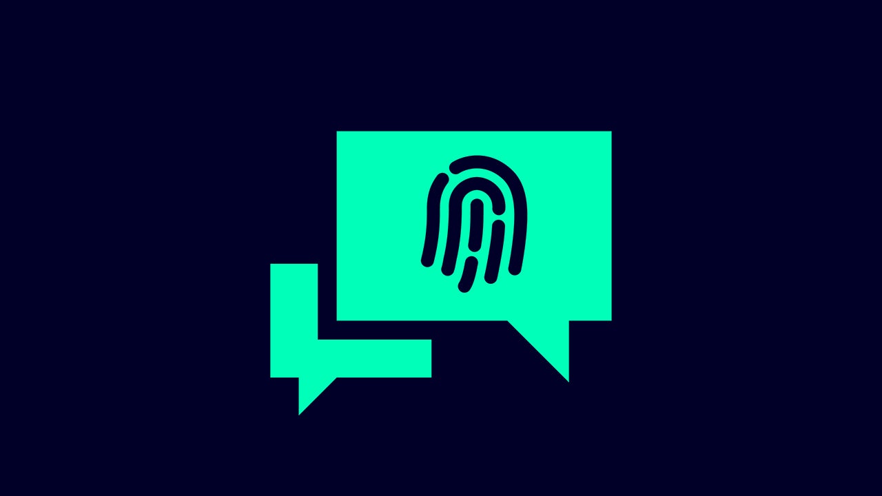 A person is working on a computer with a cybersecurity design on the screen.