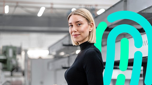 An image of a person in a suit and tie standing in front of a computer screen with a cybersecurity-related graphic.