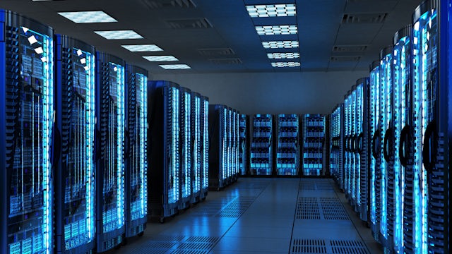 A data center interior with rows of servers and networking equipment.