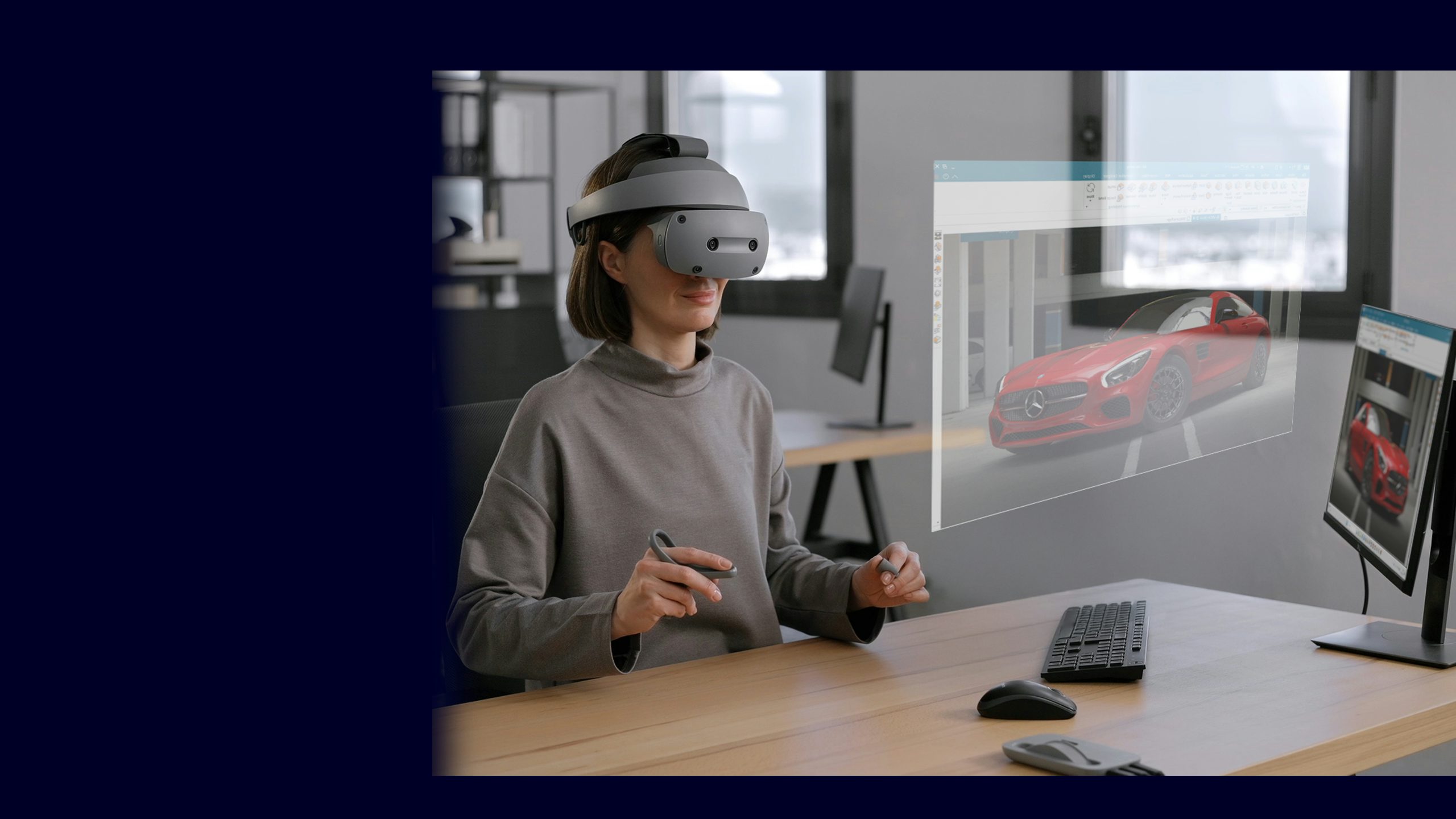 Person in black shirt standing against white wall with black border, holding a dark object.