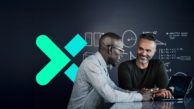 Digital transformation workspace with a large data graph screen and a professional working on a laptop.