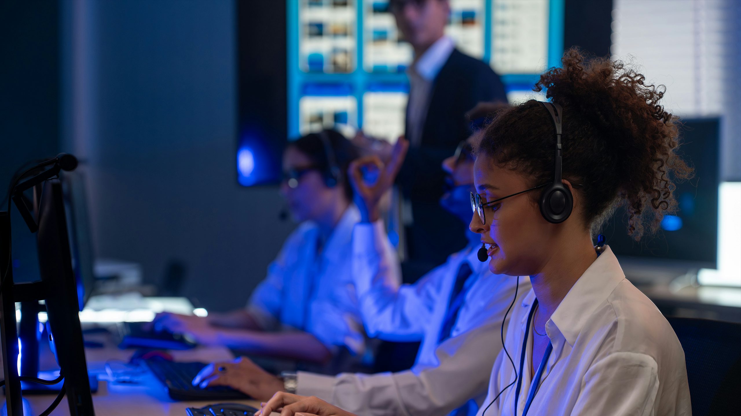 The image shows a digital transformation key visual with a customer service agent working at night.