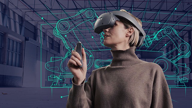Woman wearing a VR headset interacting with a Siemens digital twin of robotic arms in the background.