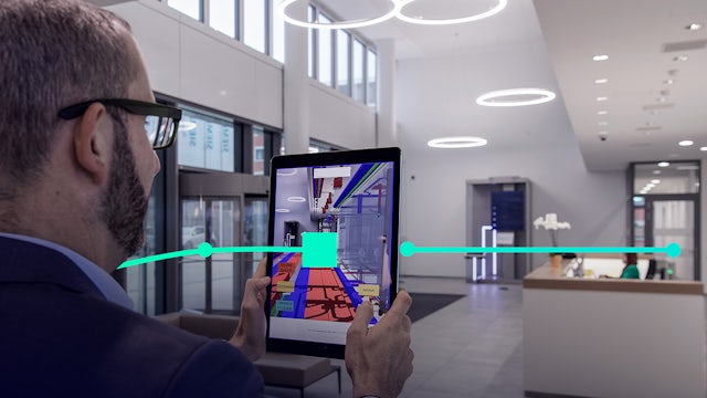 Engineer using digital twin with augmented reality in commercial space  