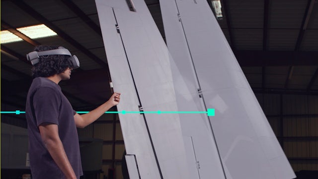 Engineer using AR to interact with aircraft panel designs for precision  