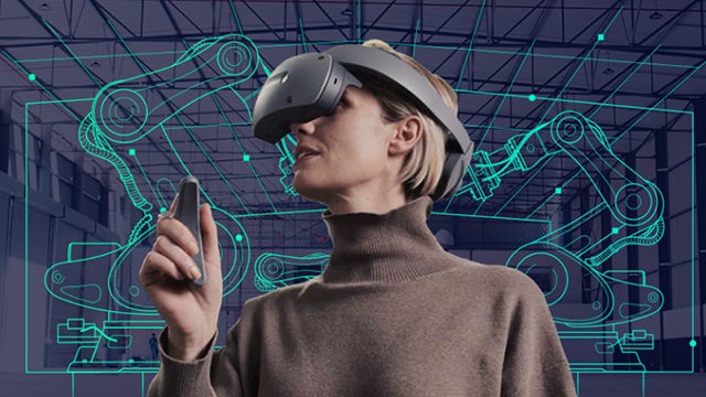 Person wearing VR headset controlling robotic arm in manufacturing setting