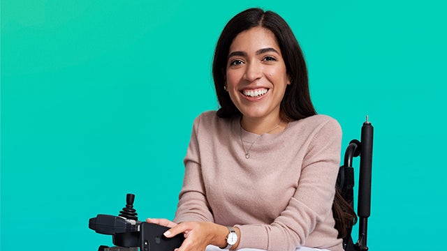 A person with a disability is being included in a group activity, with a focus on their abilities and contributions.