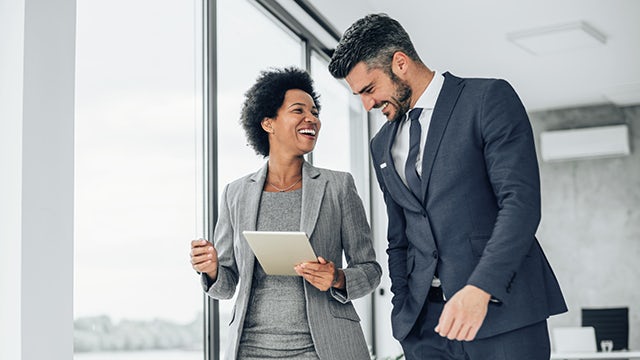 Two people laughing and smiling.