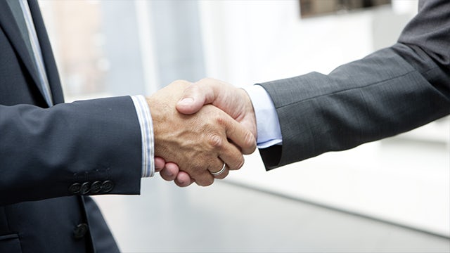 Two people shaking hands.