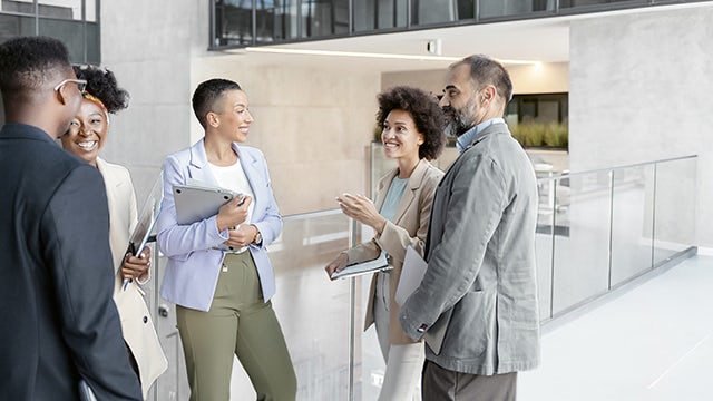 A group of people in a meeting in an office setting.