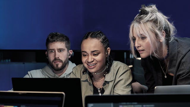 Colorful hot air balloons floating in a clear blue sky above a green landscape